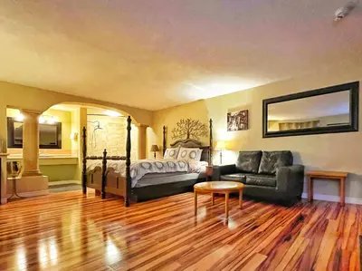 a living room with a bed and a couch at Sunny Motel Port Elgin in Port Elgin