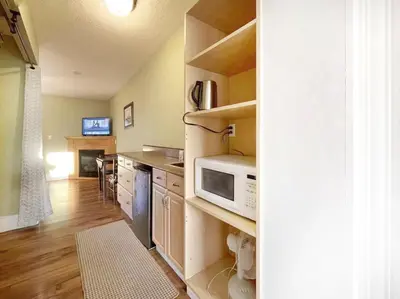 a kitchen with a stove and a microwave at Sunny Motel Port Elgin in Port Elgin