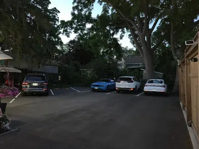 a group of cars parked in a parking lot at Ambiance by the Falls Cozy Suite in Niagara Falls