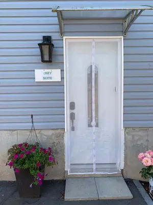 a front door of a house with a sign on it at Ambiance by the Falls Cozy Suite in Niagara Falls