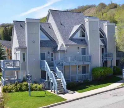a large house with blue stairs in front of it at Freshly Upgraded Cozy Studio @ North Creek Resort in Blue Mountains