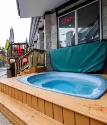 a jacuzzi tub in front of a building at Freshly Upgraded Cozy Studio @ North Creek Resort in Blue Mountains