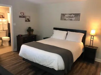 a bedroom with a large bed and a bathroom at Freshly Upgraded Cozy Studio @ North Creek Resort in Blue Mountains