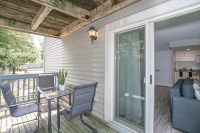 a patio with a table and chairs and a sliding glass door at Slopeside Sanctuary - Ski In/Ski Out in Blue Mountains