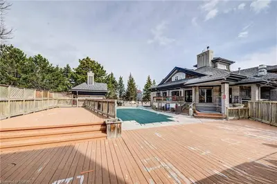 a large house with a deck and a building at Slopeside Sanctuary - Ski In/Ski Out in Blue Mountains