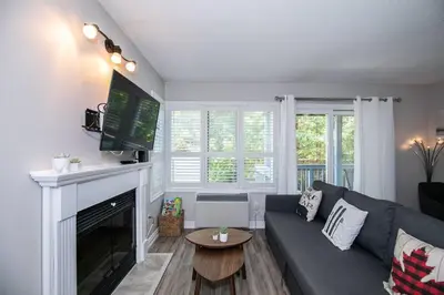 a living room with a couch and a fireplace at Slopeside Sanctuary - Ski In/Ski Out in Blue Mountains