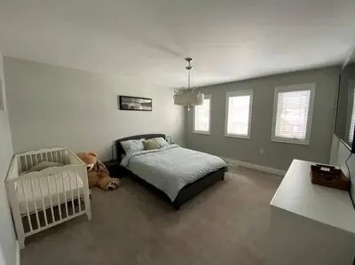 a bedroom with a bed and a teddy bear at Cozy 3 bedroom home perfect for small gatherings in Barrie
