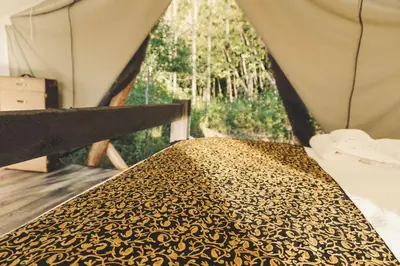 a close up of a bed in a tent at Fronterra Wellness Farm & Camp in Hillier