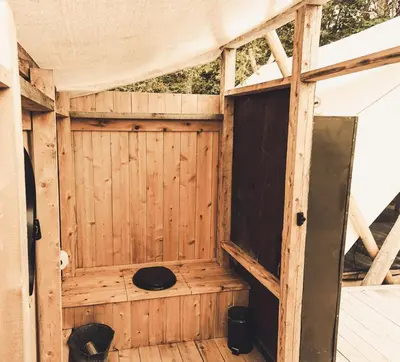 an inside of a wooden structure with a door at Fronterra Wellness Farm & Camp in Hillier