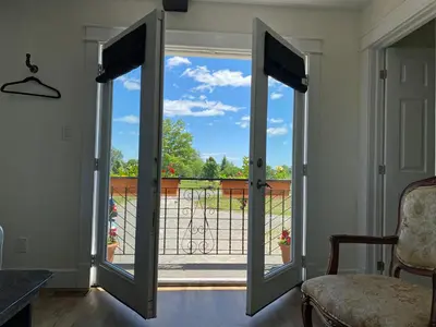 an open door with a view of a balcony at Villa di Casa - Boutique Hotel in Wellington