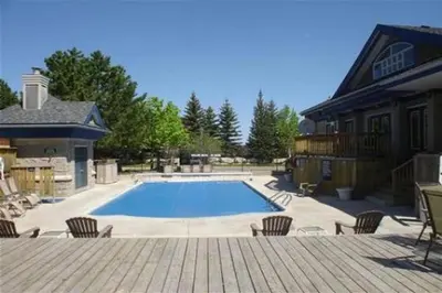 a large swimming pool in front of a house at Blue Mountain Luxury Studio in Blue Mountains