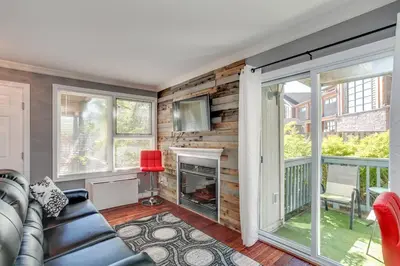 a living room with a couch and a fireplace at Blue Mountain Luxury Studio in Blue Mountains
