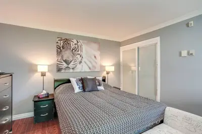 a bedroom with a bed and a painting of a tiger at Blue Mountain Luxury Studio in Blue Mountains