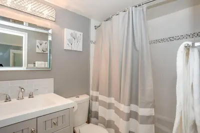 a bathroom with a sink and a shower curtain at Blue Mountain Luxury Studio in Blue Mountains