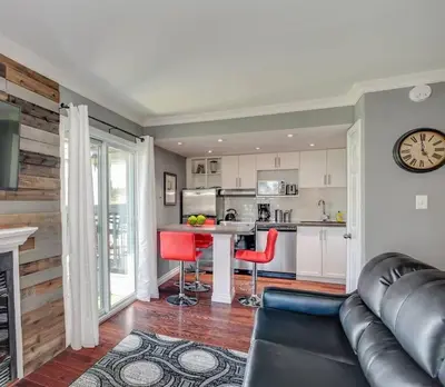 a living room with a couch and a kitchen at Blue Mountain Luxury Studio in Blue Mountains
