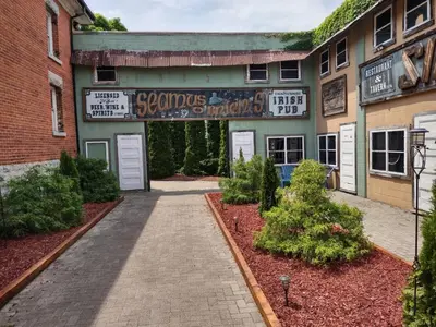 a building with a sign that reads scorpions and chickens at The King George Inn in Cobourg
