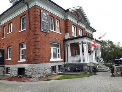 a large brick building with a sign on it at The King George Inn in Cobourg