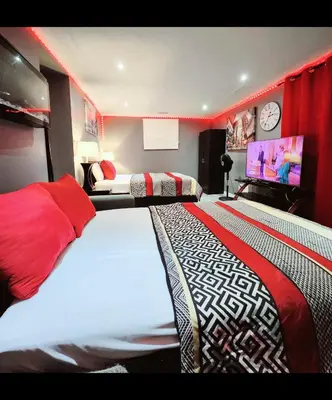 a bedroom with two beds and a flat screen tv at Staycation Studio Apartment, Private kitchen , Washroom, Micro Gym & Free Onsite Parking in London