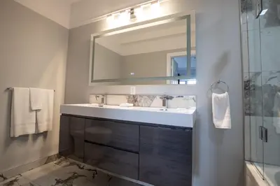 a bathroom with a sink and a mirror at Niagara Luxury Suites in Niagara Falls