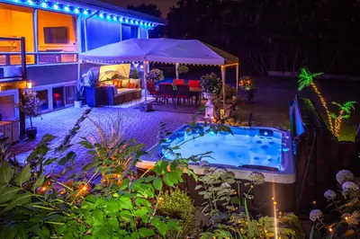 a backyard with a swimming pool at night at Nature Oasis Mar Suite in Dundas