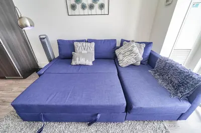a large blue couch in a living room at RHD Luxury Condos-Downtown, CN Tower, Metro Toronto Convention Centre, Rogers Centre, Free Parking in Toronto