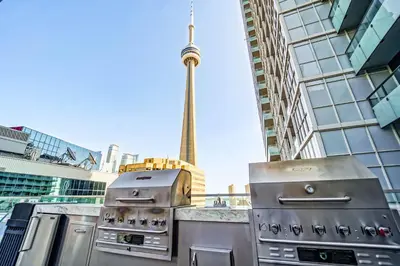 two stoves on a counter with a view of the city at RHD Luxury Condos-Downtown, CN Tower, Metro Toronto Convention Centre, Rogers Centre, Free Parking in Toronto