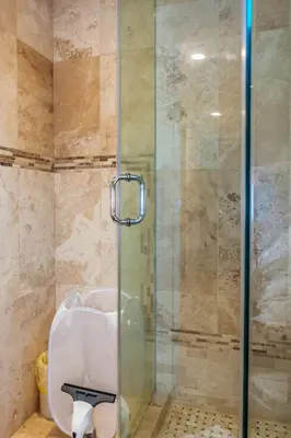 a shower with a glass door in a bathroom at Nature Oasis Bar Room in Dundas