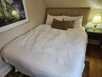 a bedroom with a white bed with two pillows on it at Four Bedroom Rosedale Home in Toronto