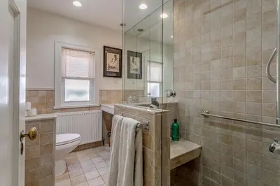 a bathroom with a toilet and a sink and a shower at Four Bedroom Rosedale Home in Toronto