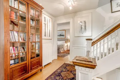 a home with a staircase and a book shelf at Four Bedroom Rosedale Home in Toronto