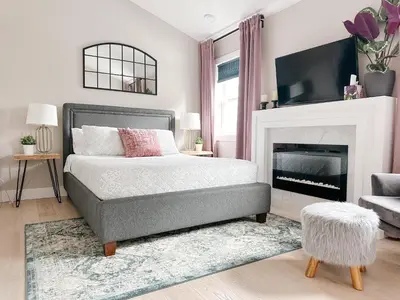 a bedroom with a bed and a fireplace at Inn On King Bed & Breakfast in Niagara on the Lake