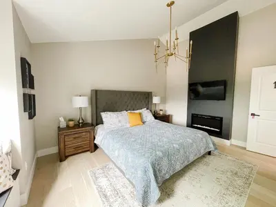 a bedroom with a bed and a chandelier at Inn On King Bed & Breakfast in Niagara on the Lake