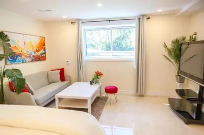 a living room with a couch and a tv at Nature Oasis BarMar 2BR Suite in Dundas close to Webster Falls in Dundas