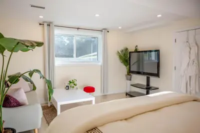 a living room with a couch and a tv at Nature Oasis BarMar 2BR Suite in Dundas close to Webster Falls in Dundas