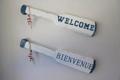 two skis hanging on a wall with the words welcome andiverpool at Plovers Cove Cottage in Wasaga Beach