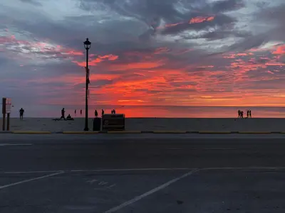 a sunset at the beach with a street light at Plovers Cove Cottage in Wasaga Beach