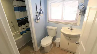 a bathroom with a toilet and a sink at Plovers Cove Cottage in Wasaga Beach