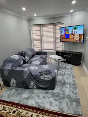 a living room with a couch and a flat screen tv at Classic & Luxury Private Detached Entire Home with Free WI-FI & T.V in Brampton