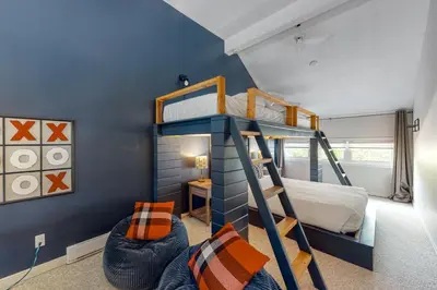 a bedroom with a bunk bed and a ladder at Wintergreen 126 in Blue Mountains