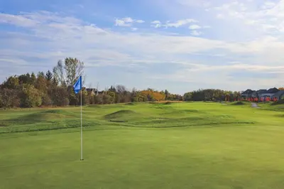 a golf course with a blue flag on the green at Wintergreen 126 in Blue Mountains
