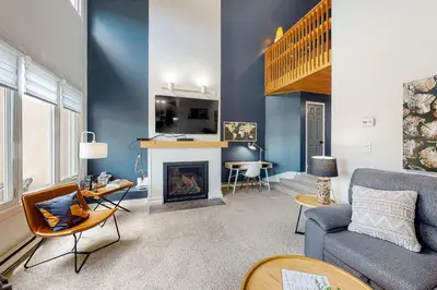 a living room with a couch and a fireplace at Wintergreen 126 in Blue Mountains