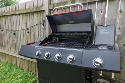 a barbecue grill with a laptop on top of it at Family-Friendly Boho Stay - Sleeps 10 - Near the Falls in Thorold
