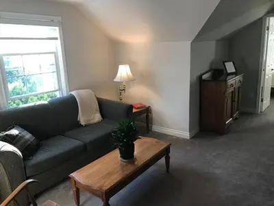 a living room with a couch and a coffee table at Upper Canada Coach House in Niagara on the Lake