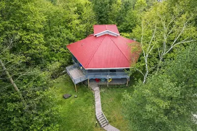 an overhead view of a tree house with a red roof at Spacious 3 Plus 1 Bedroom 2 Bath Cottage Retreat with Fire Pit and Pool Table in Brighton