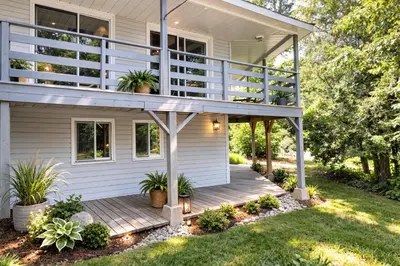a house with a porch with potted plants on it at Spacious 3 Plus 1 Bedroom 2 Bath Cottage Retreat with Fire Pit and Pool Table in Brighton