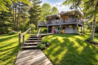a house with a staircase leading to the front yard at Spacious 3 Plus 1 Bedroom 2 Bath Cottage Retreat with Fire Pit and Pool Table in Brighton