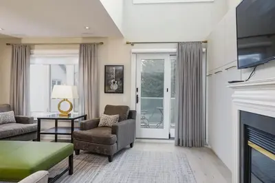a living room with a fireplace and a tv at Steps to Blue Mtn Condo wt Elegant Style 213 Sierra Lane in Blue Mountains