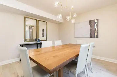 a dining room with a wooden table and white chairs at Steps to Blue Mtn Condo wt Elegant Style 213 Sierra Lane in Blue Mountains