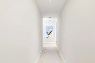an empty corridor with white walls and a white floor at Steps to Blue Mtn Condo wt Elegant Style 213 Sierra Lane in Blue Mountains