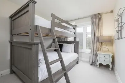 a bedroom with a bunk bed with a ladder at Steps to Blue Mtn Condo wt Elegant Style 213 Sierra Lane in Blue Mountains